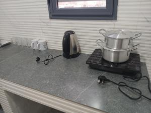 a pot on top of a stove in a kitchen at Midtown Appart Hôtel in Nouadhibou