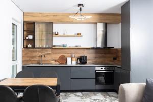 a kitchen with a sink and a stove at Garden View Apartment in Rrushkull