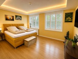 a bedroom with a bed and two windows at 4SEASONS - Golden Spring Suite in Aalborg