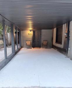 an empty garage with two chairs in it at Small Space Charm in Tampa