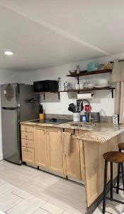 a kitchen with a counter top and a refrigerator at Small Space Charm in Tampa