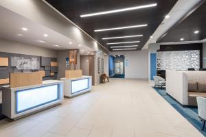 a lobby of a hospital with two large monitors at Holiday Inn Express Hotel & Suites Milton by IHG in Milton +39 photos