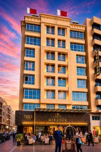 a large building with people walking in front of it at Mirador Hotel in Manama