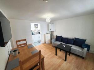 a living room with a couch and a table at Ground Floor Flat 1 Seven Cambrian square in Newtown +38 photos