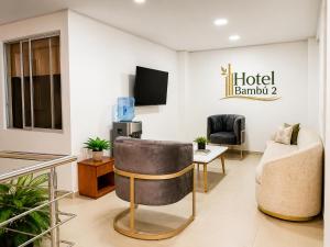 a hotel lobby with a couch and a tv at Hotel Bambù 2 in Puerto Asís