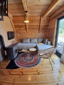 a living room with a couch and a stove at Chalet Anika in Kolašin