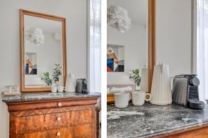 a room with a counter with a mirror and a dresser at In de Pastorie Utrecht - Old rectory, just steps away from the city center in Utrecht
