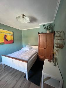 a bedroom with a bed and a cabinet and a table at Casa Vinea in Freyburg