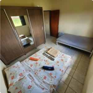 a room with a bed and a mirror at Pousada Welsh in Bueno Brandão