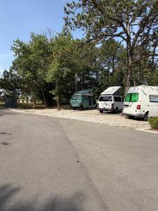 three vehicles parked on the side of a road at Glamping & Camping Green Istria in Marezige