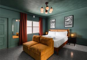 a bedroom with a bed and a chair and a window at Monaco Vacation Rentals in Clearwater Beach +227 photos