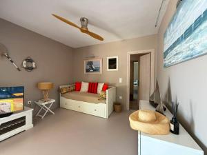 a living room with a bed and a flat screen tv at Villa Athena Ermioni in Ermioni
