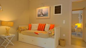 a bedroom with a white bed with orange pillows at Villa Athena Ermioni in Ermioni +34 photos