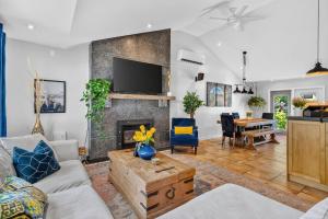 a living room with a couch and a fireplace at Waterfront Oasis with Pool, Hot Tub & Pet Friendly in Kelowna