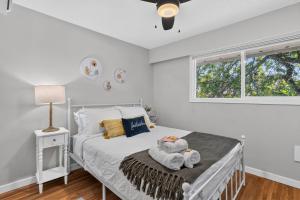 a bedroom with a bed with towels on it at Waterfront Oasis with Pool, Hot Tub & Pet Friendly in Kelowna +31 photos
