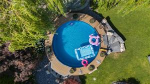 an overhead view of a large swimming pool with an inflatablelatable at Waterfront Oasis with Pool, Hot Tub & Pet Friendly in Kelowna