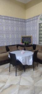 a living room with a table and a couch at Ryad dar midelt in Midelt