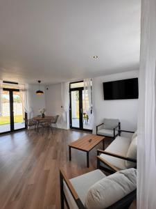 a living room with a couch and a table at Mimosa Villas in Ciolpani