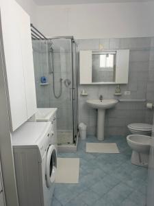 a bathroom with a shower and a sink and a toilet at Appartamenti al Rizzo dei Santi in Lovere +27 photos