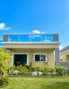 a house with a balcony on top of it at Gold Sun Villa in Saint Annʼs Bay