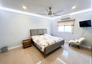 a bedroom with a bed and a ceiling fan at Gold Sun Villa in Saint Annʼs Bay