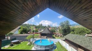 an overhead view of a house with a swimming pool at GONTA kottage - БАСЕЙН,ЧАН - Джакузі in Slavske