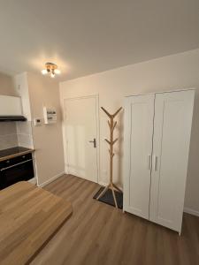 an empty kitchen with a plant in the middle of a room at Le Charles Quint in Gray +3 photos