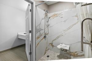 a shower with a glass door in a bathroom at Motel 6 - McComb, MS in McComb +27 photos