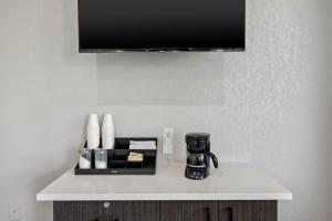 a white counter with a coffee maker and a cup on it at Motel 6 - McComb, MS in McComb