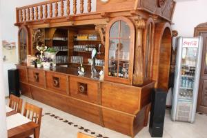 a large wooden bar in a restaurant with a refrigerator at Gościniec Kaszebe in Łeba