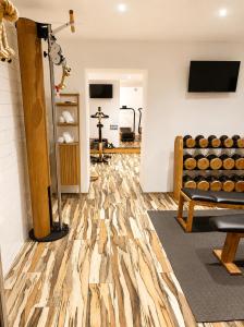 a room with a gym with wooden floors and a treadmill at Holzer II in Porto-Vecchio