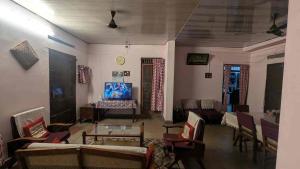 a living room with couches and a table at Le Stories Heritage Home in Kottayam