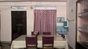 a dining room with a table and a sink at Le Stories Heritage Home in Kottayam