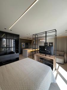 a bedroom with a bed and a desk and a couch at Neo House in Maringá +109 photos