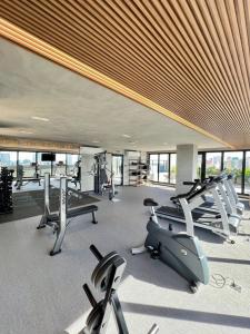 a gym with several treadmills and exercise bikes at Neo House in Maringá