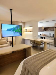 a bedroom with a large flat screen tv on the wall at Neo House in Maringá