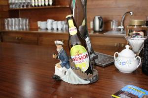 a bottle of beer sitting on a table at Gościniec Kaszebe in Łeba +41 photos
