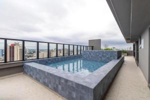 a swimming pool on the roof of a building at Neo House in Maringá