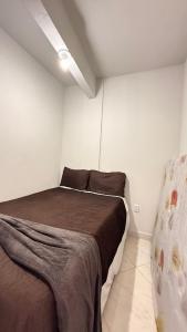 a bedroom with a bed in a white room at Apto 4, em Paty do Alferes in Paty do Alferes +6 photos