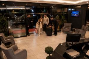 a group of people standing in a lobby with luggage at SWEET HOME SUiTE HOTEL in Trabzon