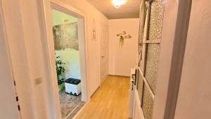 an empty hallway with a door open to a room at Ferienwohnung Glück auf in Gornsdorf +23 photos