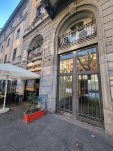a building with large glass doors on a street at Appartamento Duomo-Monte Nero in Milan