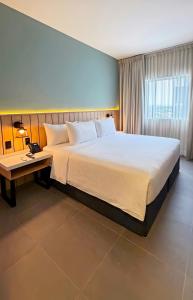 a hotel room with a large bed and a desk at Wyndham Garden Durango in Durango