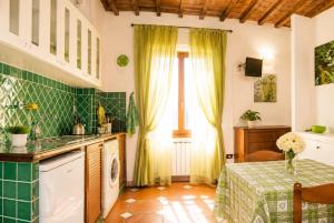 a kitchen with a table and a sink and a window at Max Studios Florence in Florence
