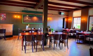 a dining room with tables and chairs in a restaurant at Hotel Restaurant 't Ronde Loegh in Winschoten +23 photos