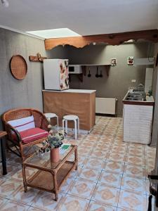 a kitchen with a chair and a table in a room at Apart Hotel Punto Real in Curicó