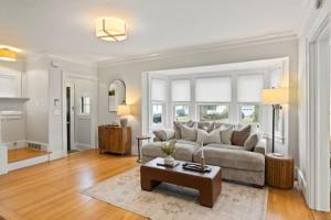 a living room with a couch and a coffee table at Rochester Gem: 3BR Near All! in Rochester