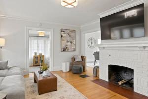 a living room with a couch and a fireplace at Rochester Gem: 3BR Near All! in Rochester