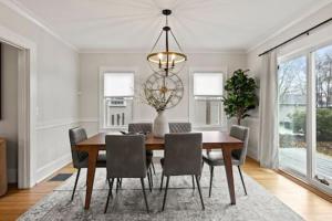 a dining room with a table with chairs and a chandelier at Rochester Gem: 3BR Near All! in Rochester