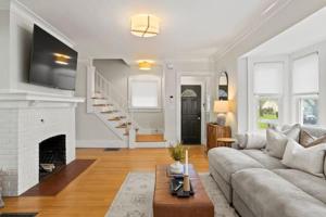 a living room with a couch and a fireplace at Rochester Gem: 3BR Near All! in Rochester +36 photos
